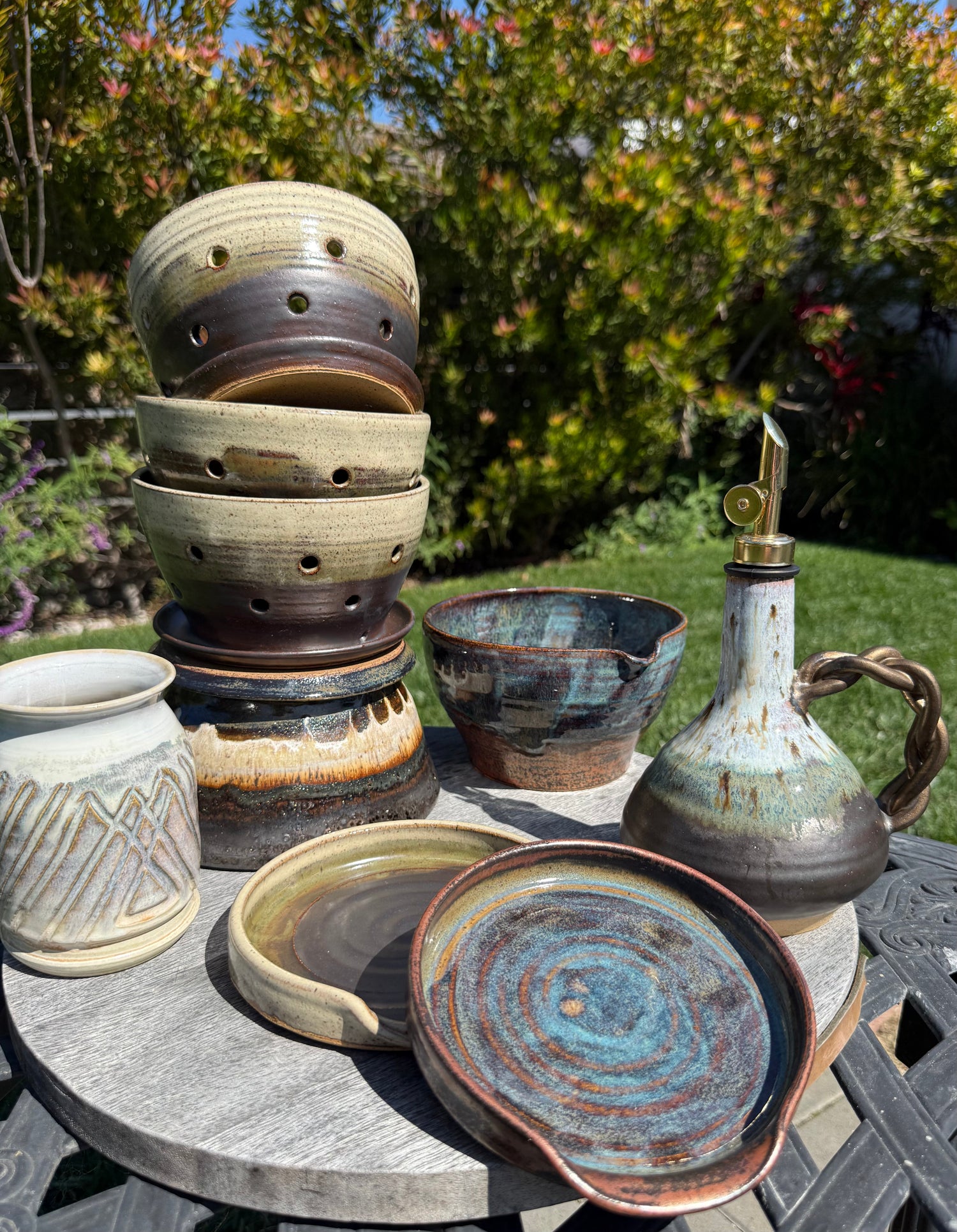 Handmade ceramic chip and dip platter with multicolor glaze, displayed outdoors