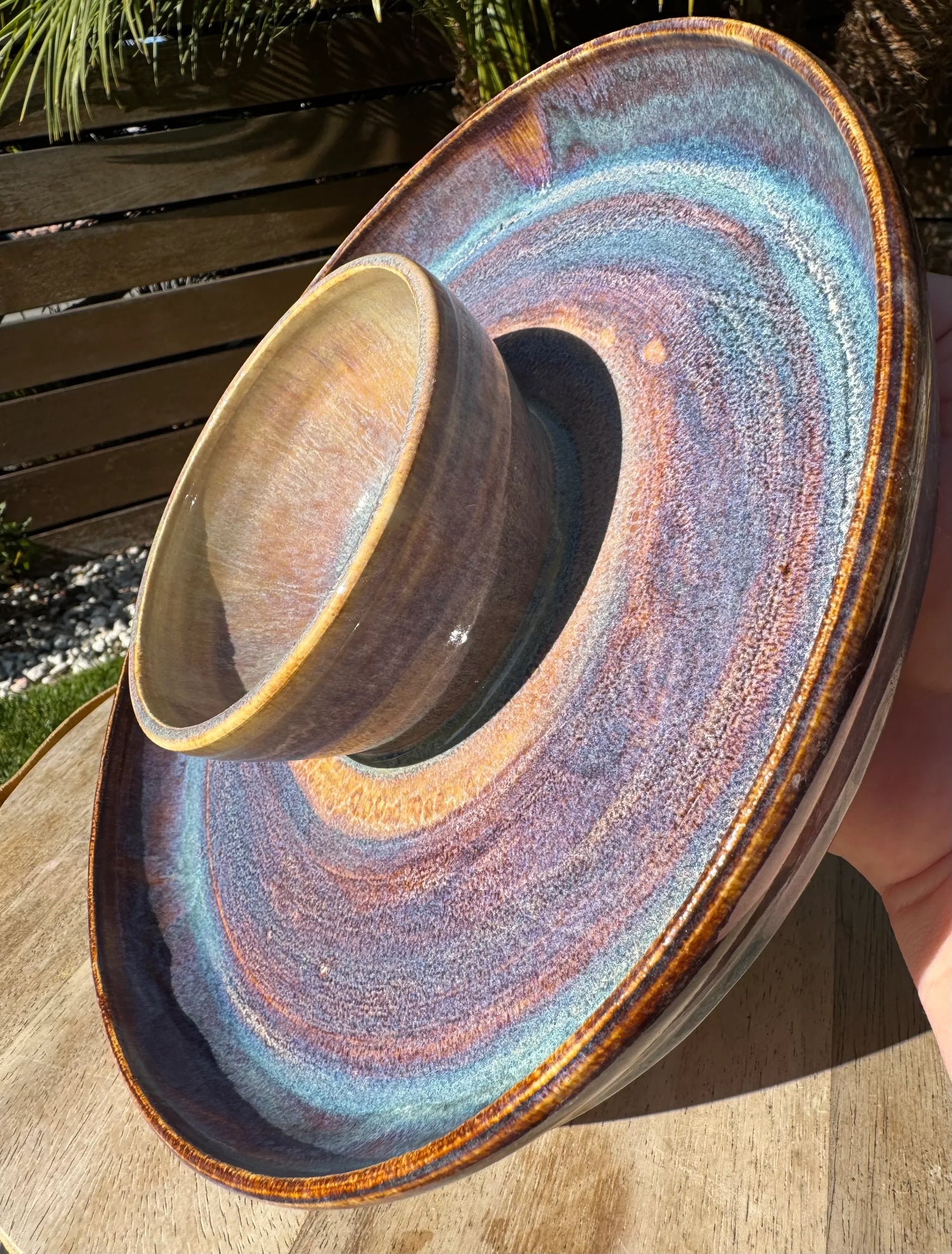Handmade ceramic chip and dip platter with multicolor glaze, displayed outdoors