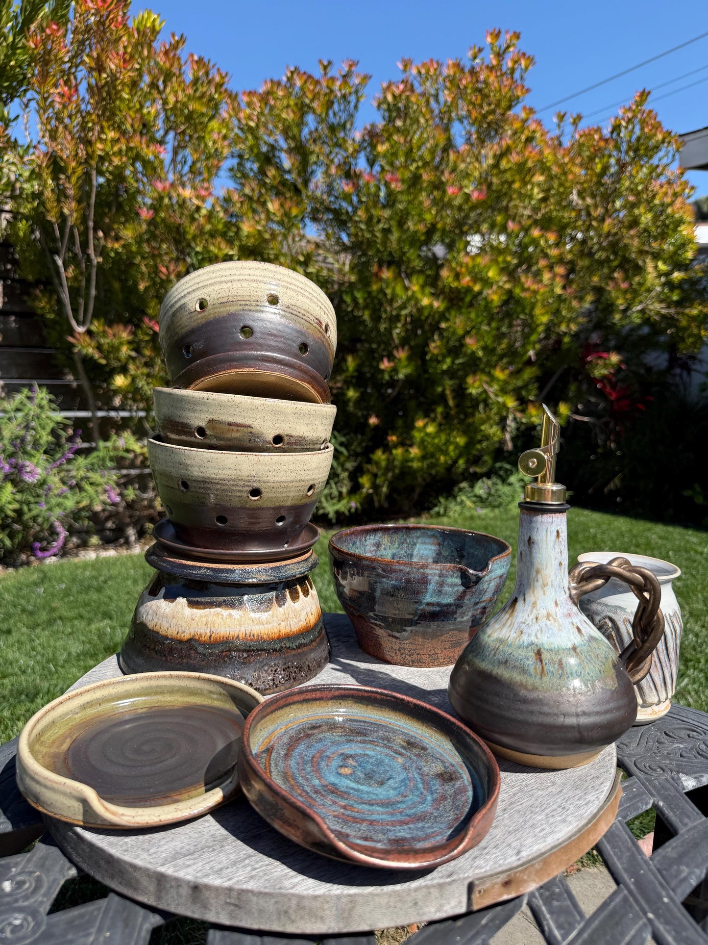 Handmade ceramic spoon rest, multiple pieces espresso oat glaze and copper deep sea blue handpainted glazes, wheel-thrown stoneware kitchen decor and art for your countertop, dishwasher safe, full shot of multiple pieces for your kitchen - Ceramics By Cou